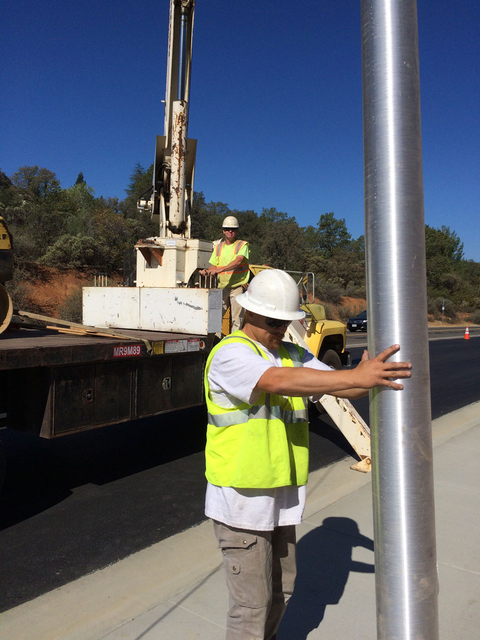 Bullert Team Member Installing an Electrical Pole