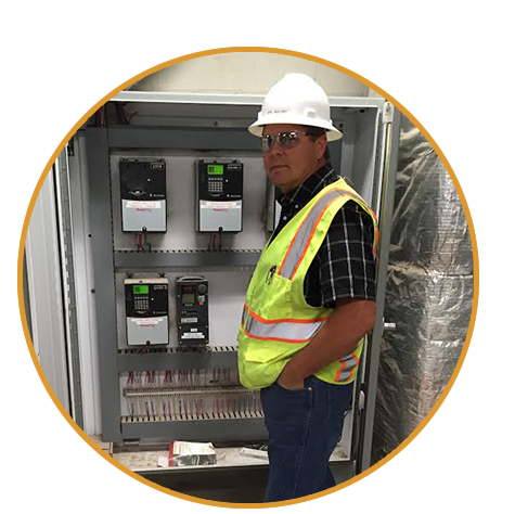 Photo of Eric Bullert Standing by Electric Controls